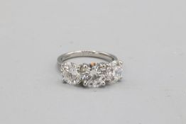 Hallmarked platinum lab-created 5ct total diamond trilogy ring, comprising a central round