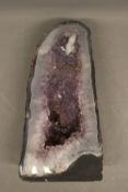 Amethyst "cathedral" geode, a free-standing cut-through specimen displaying a hollow interior cavity