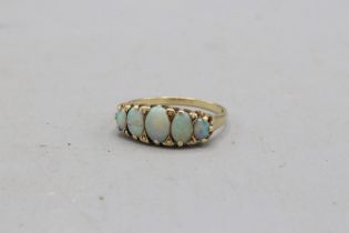 Hallmarked 9ct yellow gold opal boat-head ring, comprising five graduating oval opals, one of