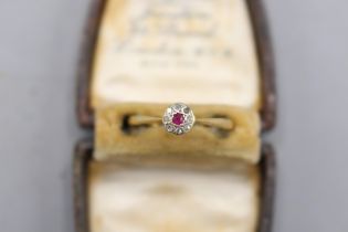 18ct yellow gold and platinum ruby and diamond halo ring, comprising a central ruby, approximately