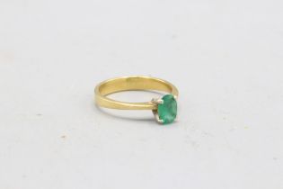 Stamped 18ct yellow gold emerald solitaire ring, comprising one oval faceted emerald measuring