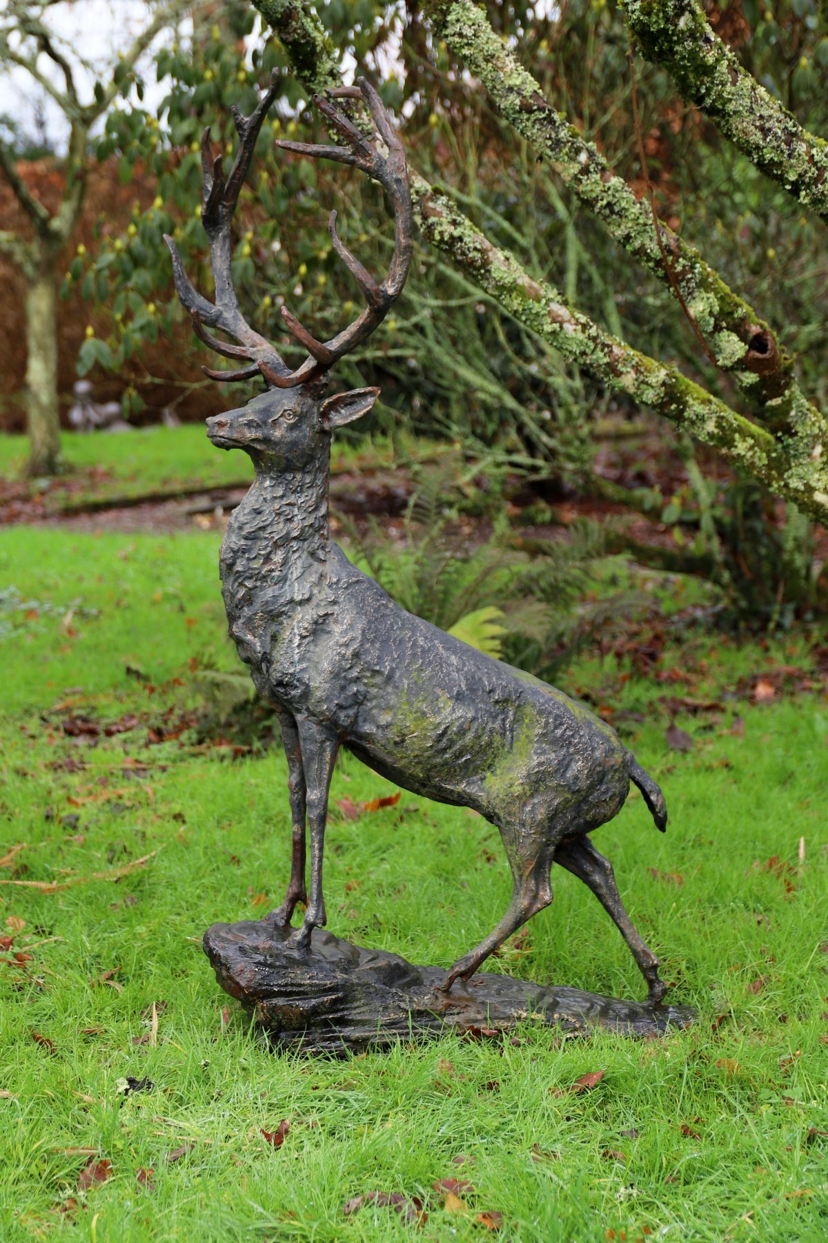 A life-size cast iron sculpture of a standing stag, modelled with ...