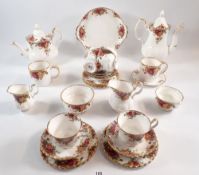 A Royal Albert Country Roses tea set including six each of cups, saucers and tea plates, two milk