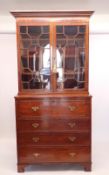 A 19th century mahogany secretaire bookcase with a pair of glazed doors over secretaire drawer and