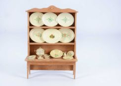 An 19th century dolls’ house pine dresser with fine German painted wooden dinner service,