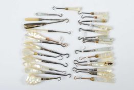 Twenty eight mother of pearl, abalone and shell button or glove hooks,