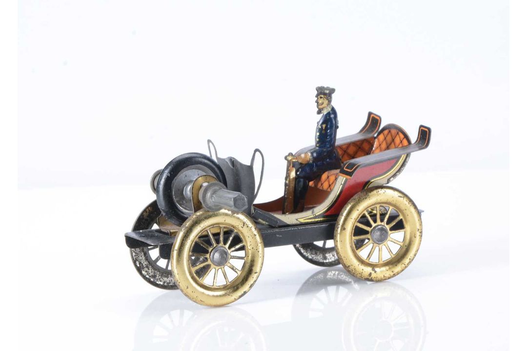 An early 20th century German fly-wheel driven tinplate automobile ...