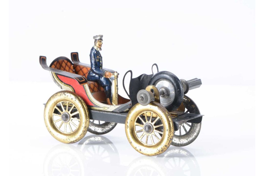 An early 20th century German fly-wheel driven tinplate automobile ...
