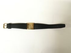 A 14k gold vintage Omega watch case of square shape on leather strap. Approx 2.5 x 2.5cm x L23cm.