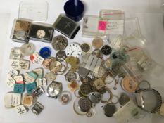A bag of assorted watch parts including Omega