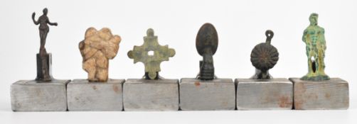 Antiquities a collection of Roman and later artefacts, mounted on steel plinths, tallest 8cm
