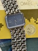 Omega De Ville silver wristwatch ref. 1011 with white hands and hour markers, blue dial, bevelled