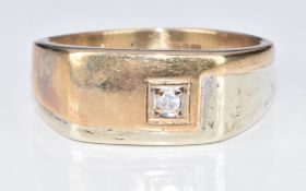 A 9ct bi-coloured gold ring set with a diamond, 6g, size T