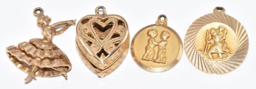 Four 9ct gold charms including St Christopher, ballerina, ring box opening to reveal a ring and a