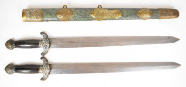 A pair of Chinese shuang duan jian (double short swords) each with reeded horn handle, ornate