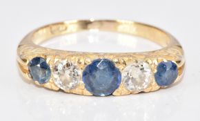 An 18ct gold ring set with three round cut sapphires, the centre sapphire approximately 0.35ct,