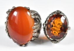 A silver ring with textured shoulders and set with carnelian agate, and a silver ring set with an
