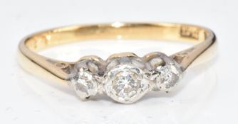 An 18ct gold ring set with three diamonds in a platinum setting, 2.6g, size O/P