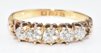 An 18ct gold ring set with five old cut diamonds, the centre diamond approximately 0.2ct, in Art