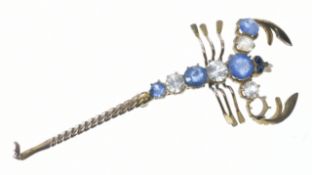A yellow metal brooch in the form of a scorpion set with sapphires and white sapphires, 3.4g, 6cm (