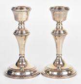 Pair of Elizabeth II hallmarked silver candlesticks, Birmingham 1961, maker W I Broadway & Co,