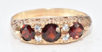 A 9ct gold ring set with garnets and cubic zirconia, 3g, size P/Q