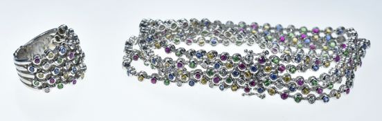 An 18k white gold ring and matching bracelet set with fancy sapphires, rubies, green garnets and