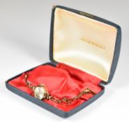 Ingersoll 9ct gold ladies wristwatch with gold hands and hour markers, silver dial and 17 jewel