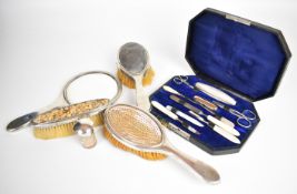 George V hallmarked silver dressing table set comprising hand mirror and three brushes, Birmingham