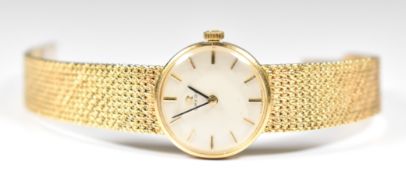 Omega 9ct gold ladies wristwatch with black hands, two-tone baton hour markers, silver dial and