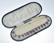 Edwardian necklace made up of a single strand of seed pearls and fifteen oval cut amethysts, the