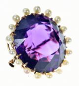 Edwardian 9ct gold pendant / brooch set with a round cut amethyst of approximately 32ct surrounded