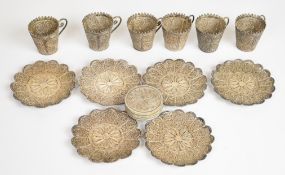 Likely Middle Eastern filigree silver coffee set comprising six cups and saucers and a lidded box,