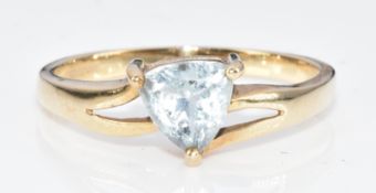 A 9ct gold ring set with a trillion cut aquamarine, 2g, size N