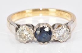 An 18ct gold ring set with a round cut sapphire and two round cut diamonds, each approximately 0.