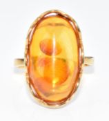 A .333 gold ring set with a pressed amber cabochon, 3.9g, size N