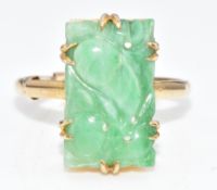A 9ct gold ring set with carved jadeite, 3.4g, size N