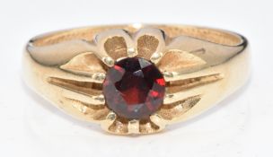 A 9ct gold ring set with a round cut garnet, 4.8g, size W