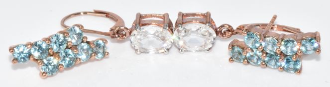 Two pairs of 9ct rose gold earrings, one set with Ratanakiri zircon and the other ice zircon, with