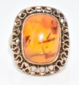 A .333 gold ring set with a pressed amber cabochon, 5.7g, size M