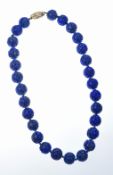 Lapis lazuli carved beaded necklace, the 14k gold clasp set with diamonds, 43cm, 89g