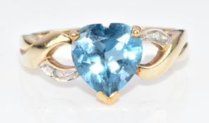 A 9ct gold ring set with a heart cut topaz and diamonds, 2.7g, size M