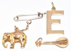 Two 9ct gold charms / pendants comprising 'E' and elephant (2.6g) and a 14k gold charm in the form