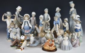 Fifteen Nao child figures and a Royal Crown Derby puffin paperweight, tallest 28cm