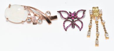 A 9ct rose gold pendant set with a white opal and topaz (6.5g), a 9ct white gold pendant in the form