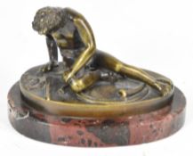 Bronze 'Dying Gaul' study of a wounded gladiator after the ancient Roman or Greek statue, on an oval