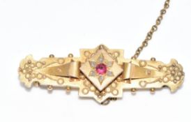 A 9ct gold brooch set with a ruby and rose cut diamonds, Chester 1900, 3.2g, 4cm