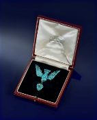 Victorian brooch in the form of a swallow set with turquoise cabochons and garnet eyes holding a