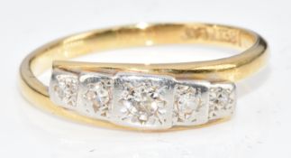 An 18ct gold ring set with five diamonds in a platinum setting, 2g, size K