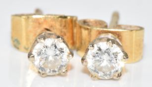A pair of 9ct gold earrings each set with a round cut diamond of approximately 0.15ct, 1.2g